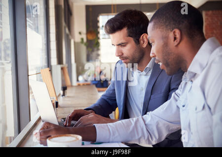 Two Businessmen Having Informal Meeting In Coffee Shop Stock Photo