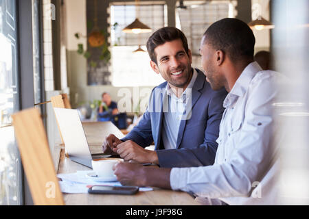 Two Businessmen Having Informal Meeting In Coffee Shop Stock Photo