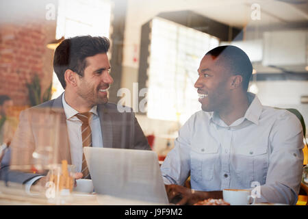 Businessmen Meeting In Coffee Shop Shot Through Window Stock Photo