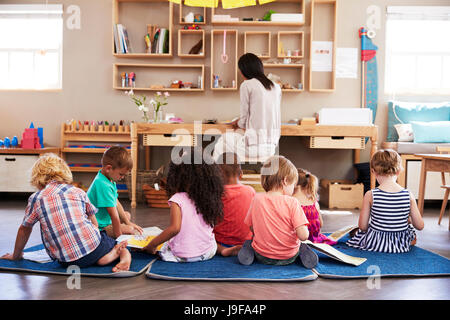 Pupils At Montessori School Reading Independently In Classroom Stock Photo