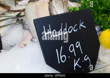 Kg price per kilogram tag board and selection of wet fish / haddock / fresh / freshly caught and for sale at West Quay Whitstable Harbour Kent UK. Stock Photo