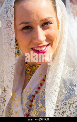 A young woman dressed in the traditional costume of the annual Las Fallas (The Fires) celebration in Valencia, Spain. Stock Photo