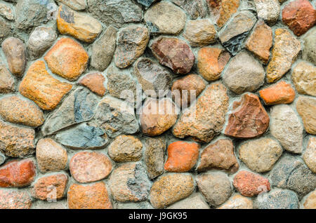 Rubble masonry wall. Stone wall made of various sizes stone, can be used as background. Stock Photo