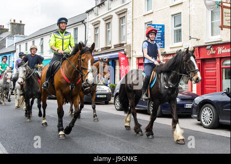 Horses ride through Schull, West Cork, Ireland during a charity cheval. Stock Photo