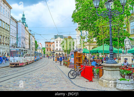 LVOV, UKRAINE - MAY 16, 2017: The view of  Market Square (Ploshcha Rynok) with riding tram, outdoor cafe next to the statue of Greek goddess Diana and Stock Photo