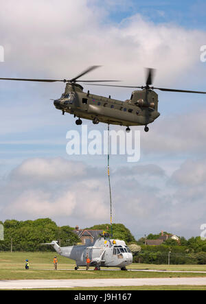 Culdrose, UK. 1st Jun, 2017. Final Flight – but with a hot future. Two retired aircraft made their final flights from RNAS Culdrose today with the helping hand of a Chinook helicopter. The old Royal Navy aircraft were moved across the Lizard Peninsula as ‘under-slung loads’ by a heavy lift RAF helicopter, and taken to their final resting place at Predannack airfield.  Credit: Bob Sharples/Alamy Live News Stock Photo