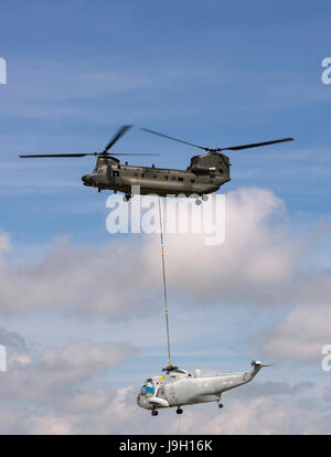 Culdrose, UK. 1st Jun, 2017. Final Flight – but with a hot future. Two retired aircraft made their final flights from RNAS Culdrose today with the helping hand of a Chinook helicopter. The old Royal Navy aircraft were moved across the Lizard Peninsula as ‘under-slung loads’ by a heavy lift RAF helicopter, and taken to their final resting place at Predannack airfield.  Credit: Bob Sharples/Alamy Live News Stock Photo