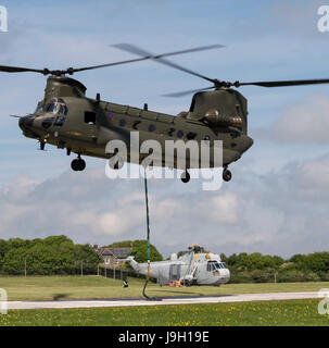 Culdrose, UK. 1st Jun, 2017. Final Flight – but with a hot future. Two retired aircraft made their final flights from RNAS Culdrose today with the helping hand of a Chinook helicopter. The old Royal Navy aircraft were moved across the Lizard Peninsula as ‘under-slung loads’ by a heavy lift RAF helicopter, and taken to their final resting place at Predannack airfield.  Credit: Bob Sharples/Alamy Live News Stock Photo