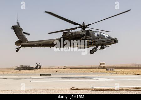 U.S. Army AH-64E Apache attack helicopters assigned to Task Force Griffin, 16th Combat Aviation Brigade, depart on a mission in support of Operation Resolute Support May 31, 2017 in Kunduz, Afghanistan. Kunduz has seen increased Taliban activity as more than 8,000 American troops and 6,000 from NATO and allied countries continue to assist the government. Stock Photo
