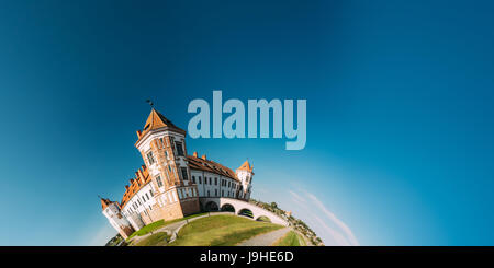 Mir, Belarus. View Of Old Towers Of Mir Castle Complex On Blue Sunny Sky Background. UNESCO Heritage. Famous Landmark In Summer In Funny Panorama Like Stock Photo