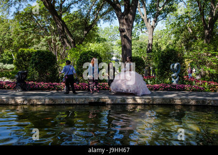 young girl dressed for the Quinceanera or Quince, the celebration of a girl's fifteenth birthday in Arboretum in Dallas, Texas Stock Photo