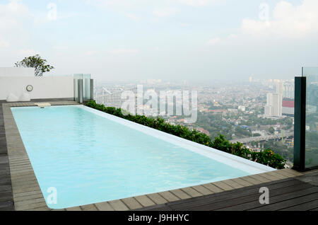 working at the top of buliding with view of Jakarta landscape Stock Photo