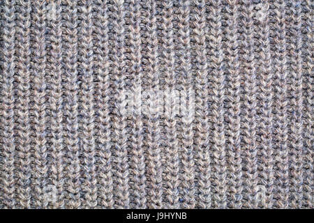 close-up of gray knitted acrylic fiber sweater texture, vertical thread patterns Stock Photo