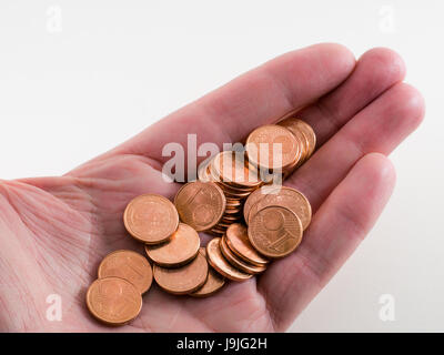 Holding some shiny bronze Euro cents in your hand Stock Photo