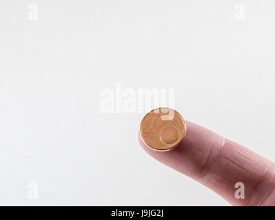 Holding 1 cent on top of your finger Stock Photo