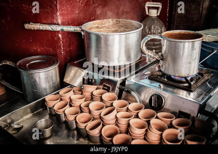 Indian tea shop in Kolkata displaying tools of the trade. Clay cups stacked near the stove prepared for making the popular milky Indian tea or Chai. Stock Photo