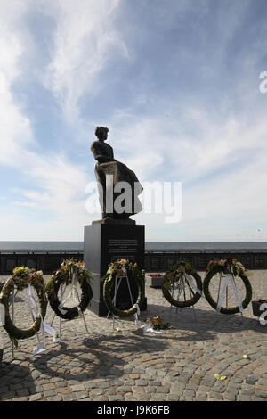 Memorial located in Urk, Netherlands, a tribute to all the men who perished at sea. The plaques on the wall lists the men in the year they were lost. Stock Photo