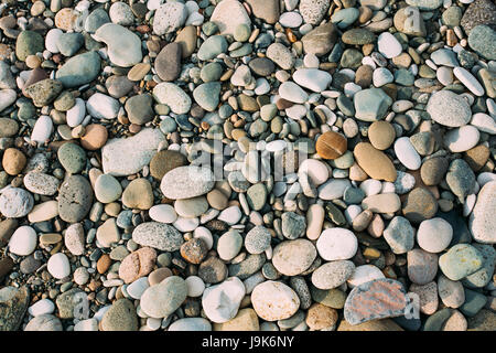 Old Pebble Stones Natural Background. Top View Of Multicolored Stones On Coast Stock Photo