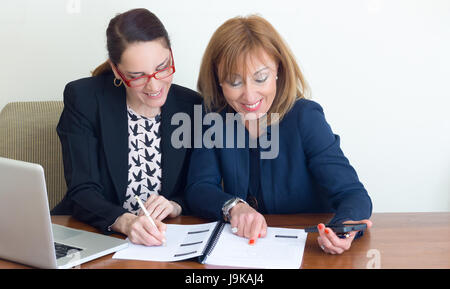 Portrait of two happy and successful mature businesswoman working together. Stock Photo