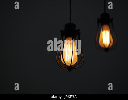 Yellow illuminated hanging light bulbs on plain background with text space Stock Photo
