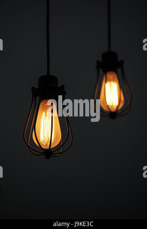Yellow illuminated hanging light bulbs on plain background with text space