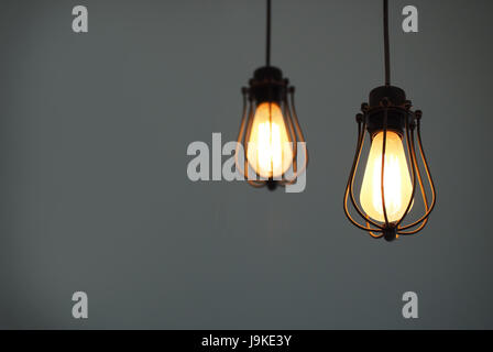 Yellow illuminated hanging light bulbs on plain background with text space