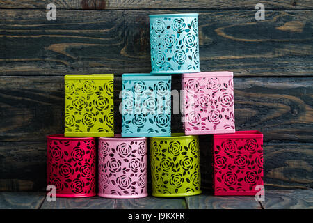 Colorful decorative metal boxes on blue wooden background Stock Photo