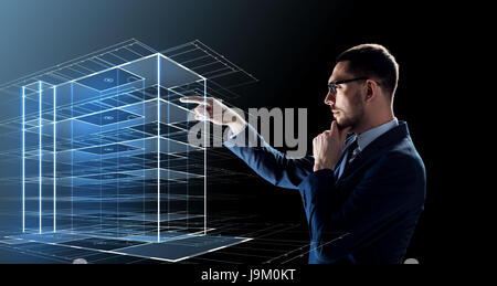 businessman in glasses with virtual building  Stock Photo
