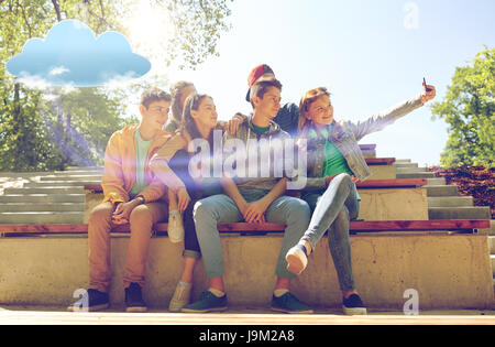 happy teenage students taking selfie by smartphone Stock Photo