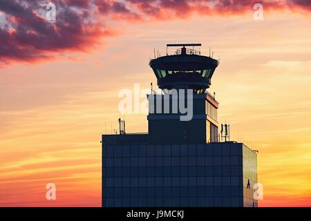 Air Traffic Control Tower at the airport during amazing sunset. Prague, Czech Republic Stock Photo