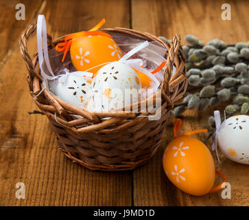 Easter eggs decorations in wicker basket Stock Photo