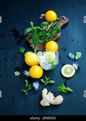 Fresh mojito ingredients with lemon, ginger, mint herb leaves and ice cubes Stock Photo