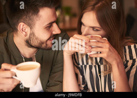Loving couple having hot drinks Stock Photo