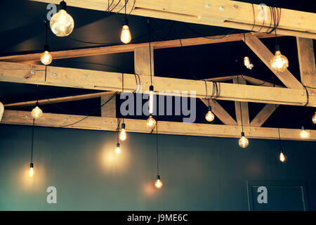 vintage style light bulbs hanging from the ceiling Stock Photo