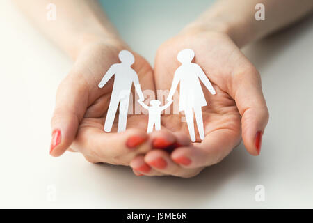 family care and insurance concept, hands with paper humans Stock Photo