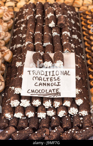 Traditional Maltese cannoli chocolate sweets and confectionery for sale on a market stall in Marsaxlokk Malta Stock Photo