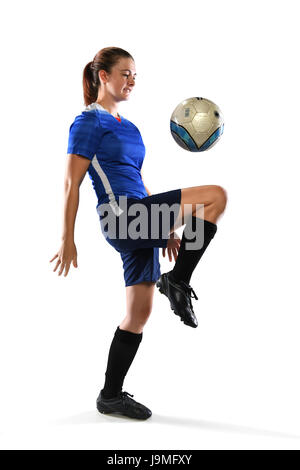 Female soccer player bouncing ball isolated over white background Stock Photo