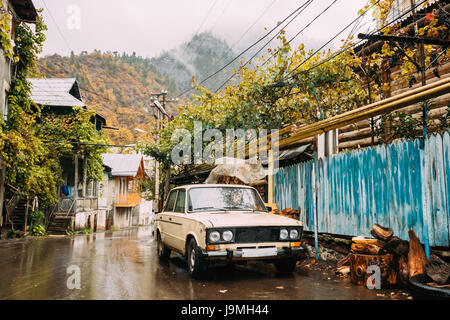 Borjomi, Samtskhe-Javakheti, Georgia. Russian Old Rusty Car Sedan Parking On Village Street In Rainy Autumn Day Stock Photo
