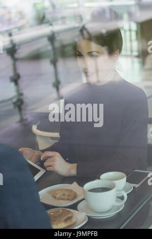 Young female executive having breakfast in cafeteria Stock Photo