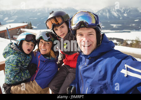 Portrait of happy family in skiwear during winter Stock Photo