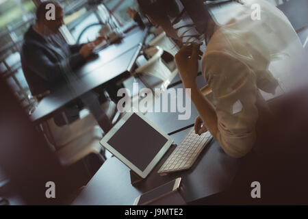 Businesswoman using digital tablet in office cafeteria Stock Photo