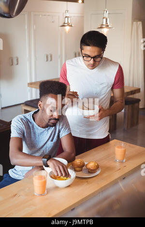 Gay couple having breakfast at home Stock Photo