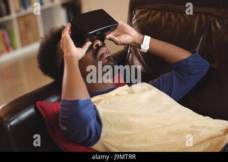 Man using virtual reality headset in the living room at home Stock Photo