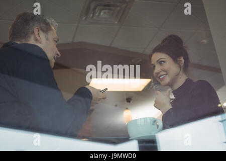 Business colleagues interacting with each other in office cafeteria Stock Photo