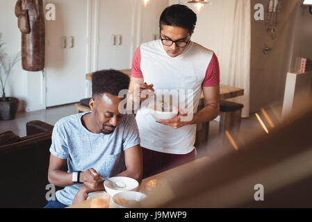 Gay couple having breakfast at home Stock Photo
