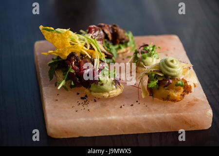 Close up food on stone tray at restaurant Stock Photo