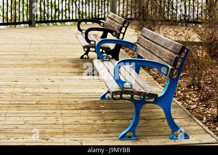 Two colorful benches on a boardwalk. Stock Photo