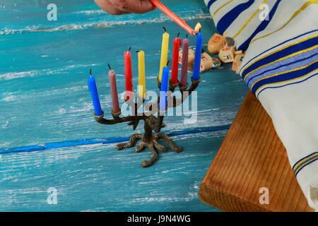 Selective focus of the Hanukkah Jewish holiday with traditional menorah, donuts Stock Photo