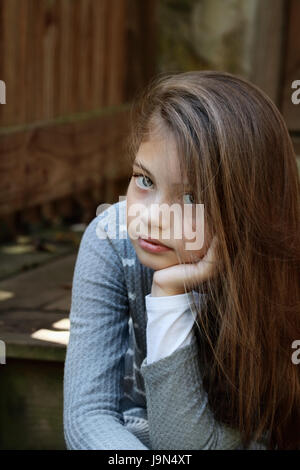 Young girl looking directly into the camera with long flowing hair. Extreme shallow depth of field.