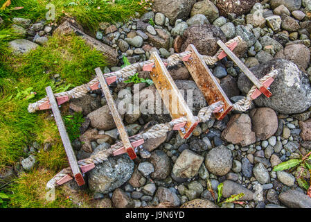 Old ships rope ladder washed up on a rocky beach in Ireland Stock Photo